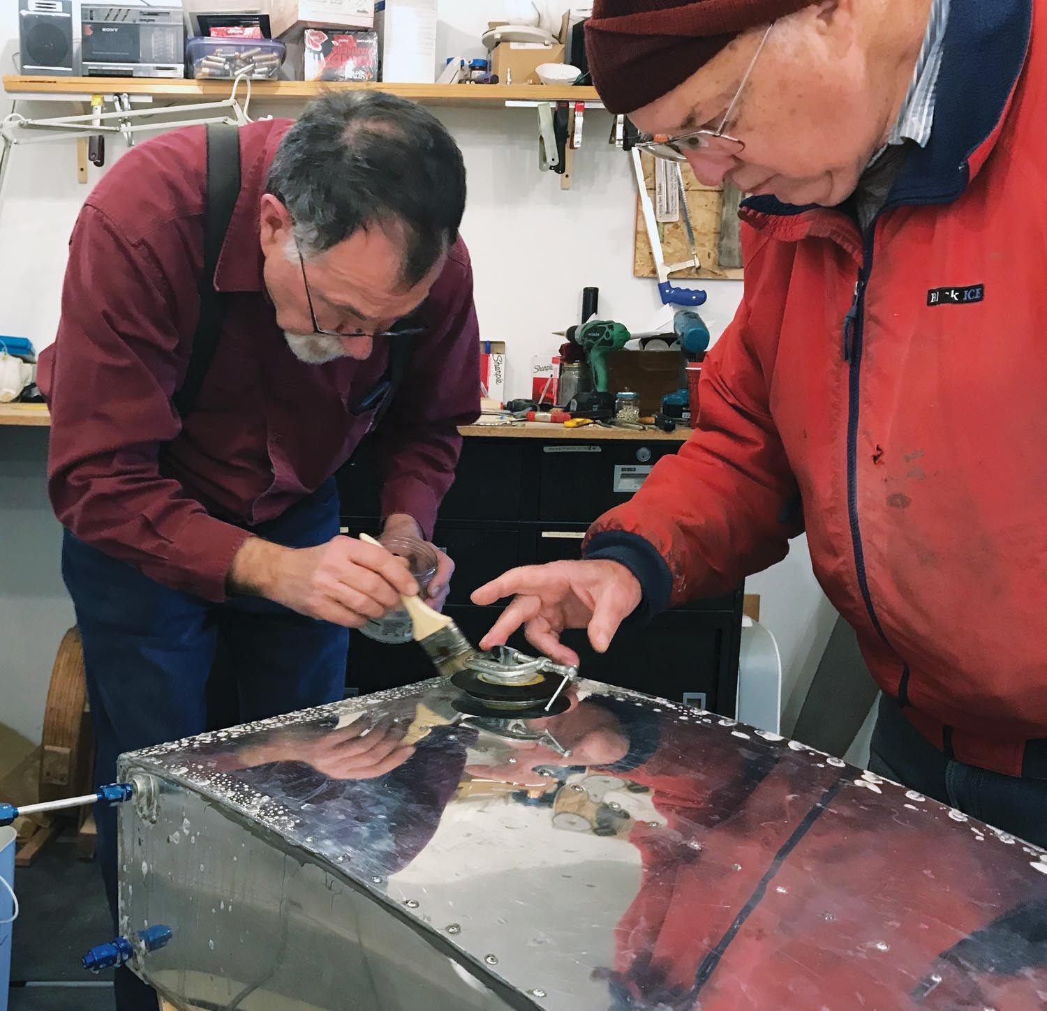 Rion Bourgeois (left) and Philip Groelz test the tank for leaks.