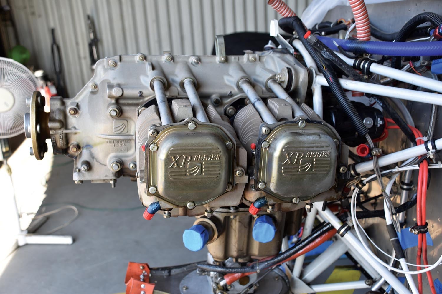 The Superior IO-360 engine stripped and ready for cylinder removal. Note that oil return lines are capped as are the intake tubes in the sump. Until the decision has been made to completely tear down the engine it is best to protect everything as you go.