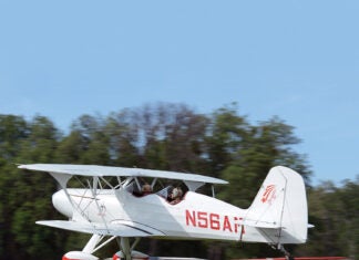 Starduster biplane over grass strip