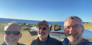 Marc Cook, Tom Hamilton, and Omar Filipovic at AirVenture 2022. Tom Hamilton is the designer of the GlaStar experimental, seen in the background.