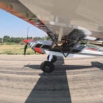 Taildragger aircraft at the point of transition from taxiing to flight.