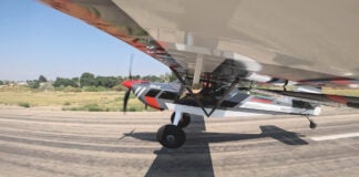 Taildragger aircraft at the point of transition from taxiing to flight.