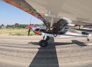 Taildragger aircraft at the point of transition from taxiing to flight.