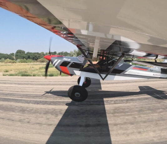 Taildragger aircraft at the point of transition from taxiing to flight.