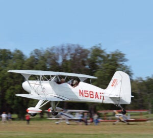 Starduster biplane over grass strip