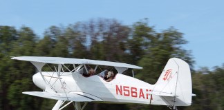 Starduster biplane over grass strip