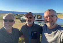 Marc Cook, Tom Hamilton, and Omar Filipovic at AirVenture 2022. Tom Hamilton is the designer of the GlaStar experimental, seen in the background.