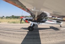 Taildragger aircraft at the point of transition from taxiing to flight.