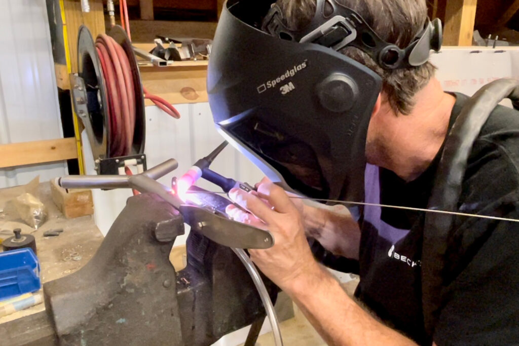 Humberd Tig welding the last pieces to complete the new control stick.