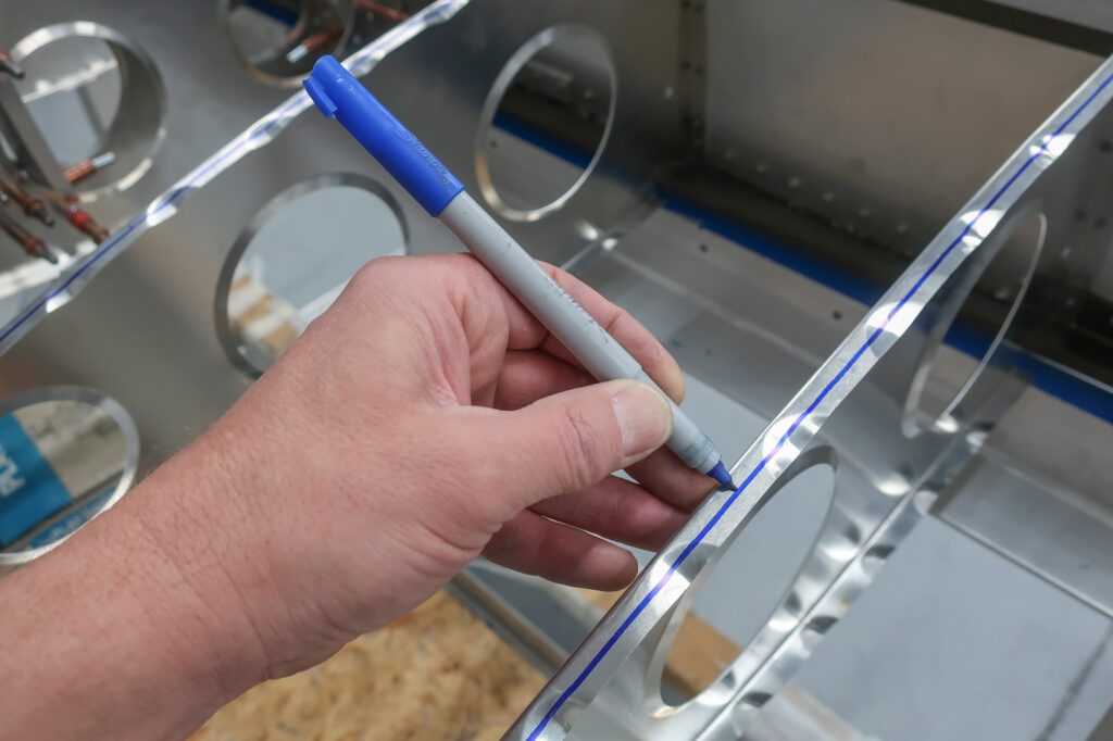 A centerline on a rib flange is a visual aid to align a rib to assure the rivets pass through the flange with proper edge distance. Its hard to get that wrong if an honest effort is made at eye-balling a thin (or thick) centerline on a rib’s flange.