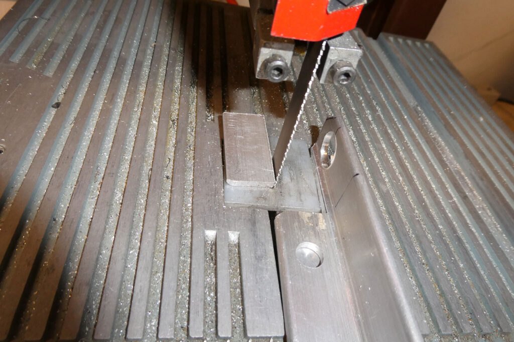 Verifying that everything lines up with the close-fit holes. This photo shows how much the bracket protrudes below the wing surface. The center wing is nose down in a cradle, which is why you are seeing the hangar roof.
