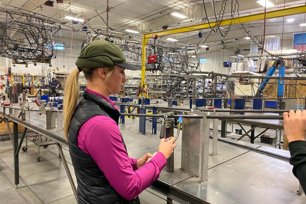 Jackie is heating a fuselage longeron to soften the steel before bending.