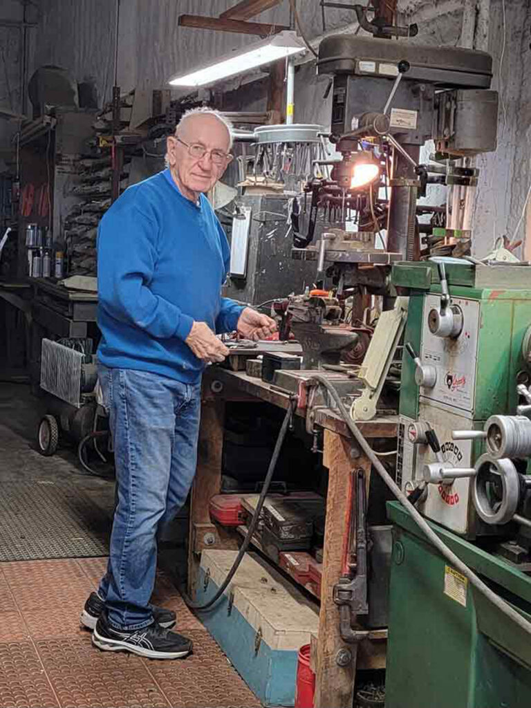 Leonard Milholland at work in his machine shop.