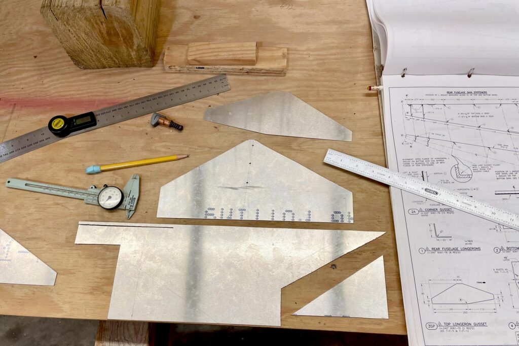 Laying out the modified top longeron gussets on scrap aluminum.